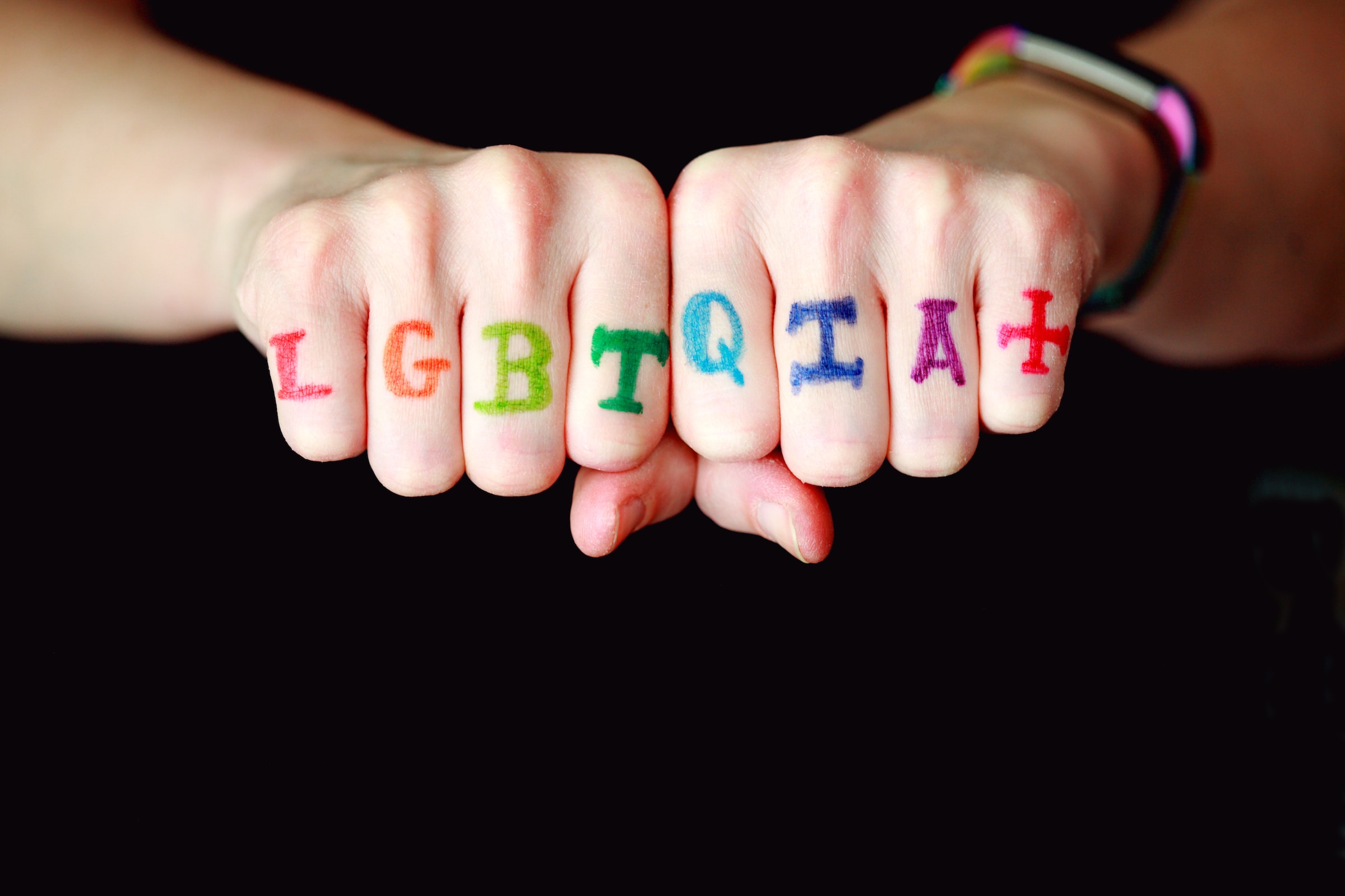 lgbtq written on fists