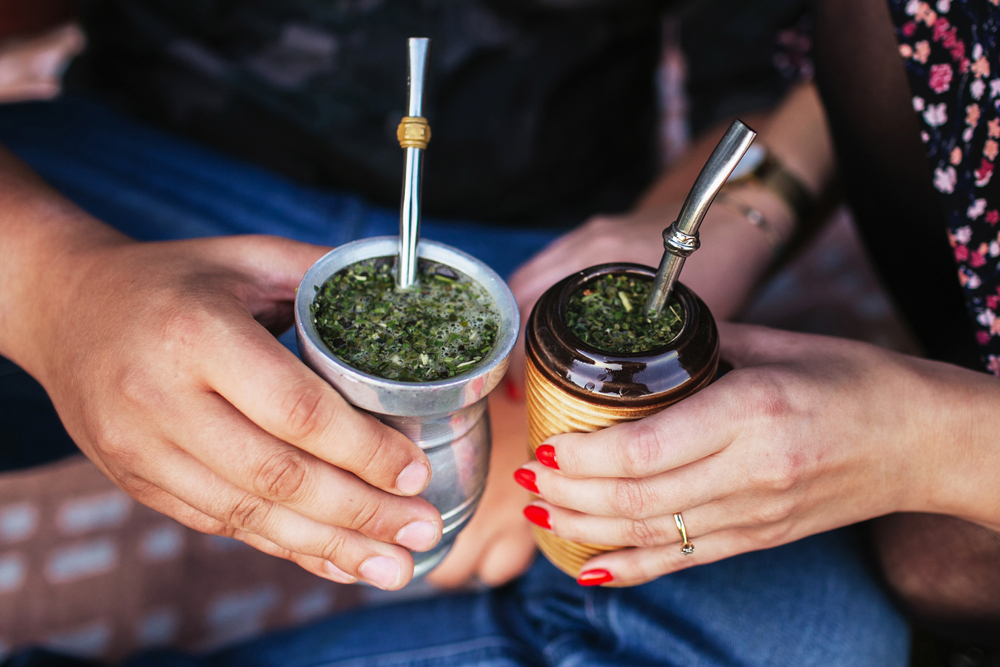 two hands holding Delicious yerba mate