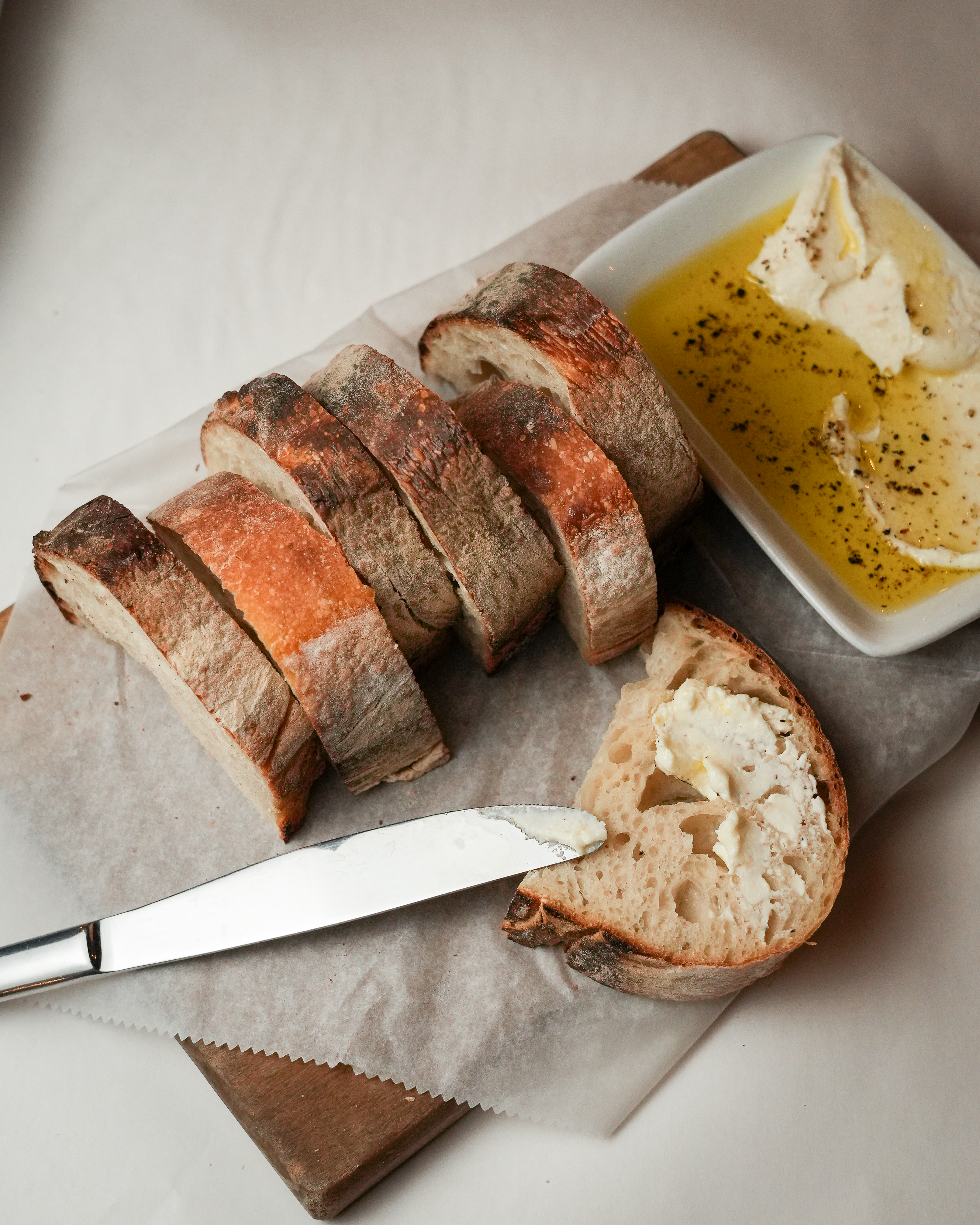 bread and butter with a knife on a board